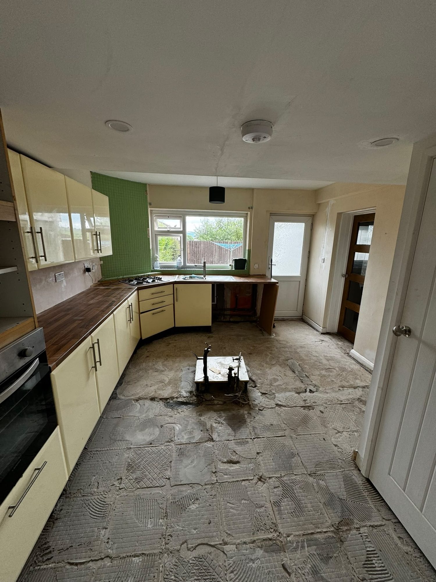 Kitchen floor substrate after asbestos tile removal in Anglesey