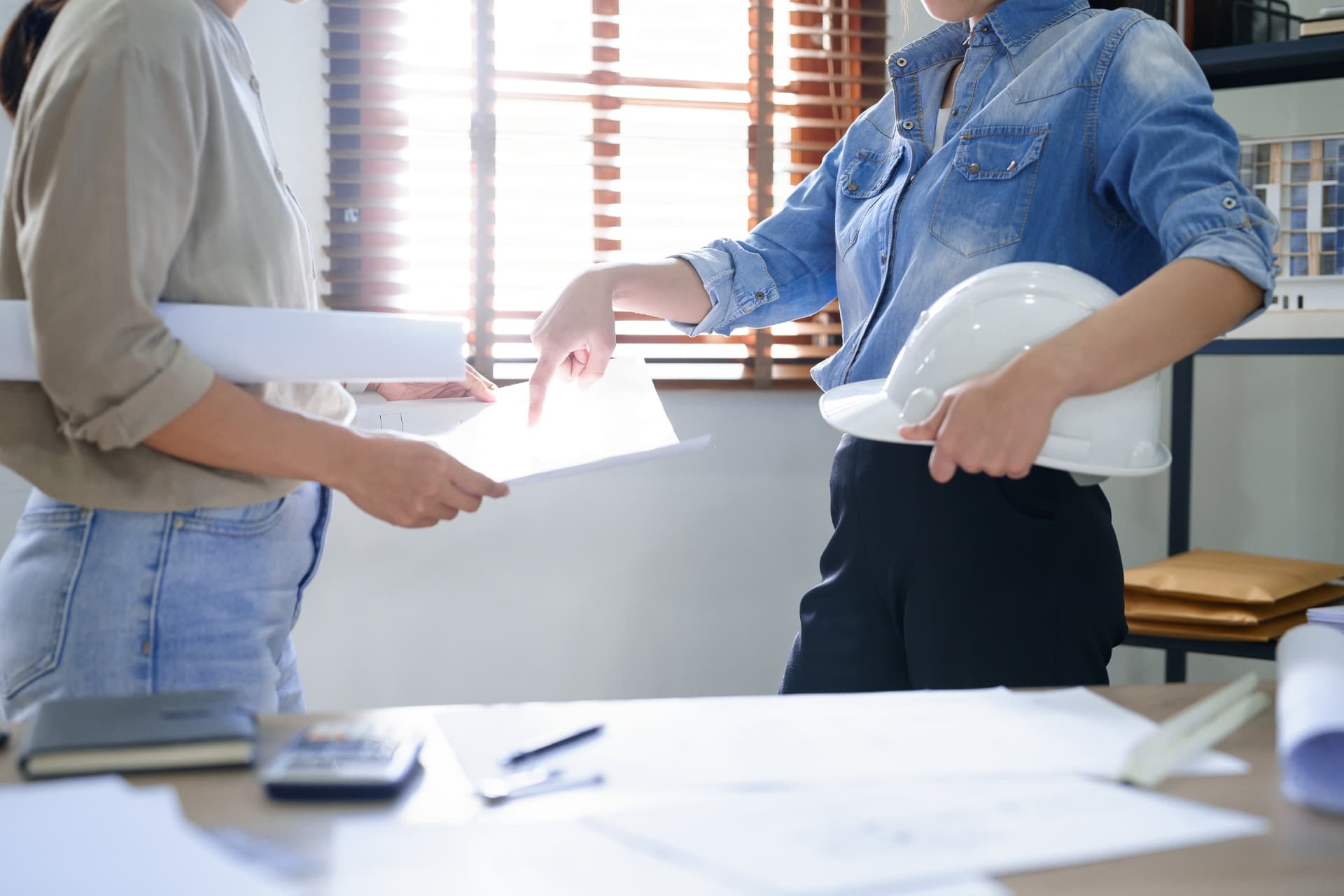 Asbestos consultant reviewing plans and documents with a client