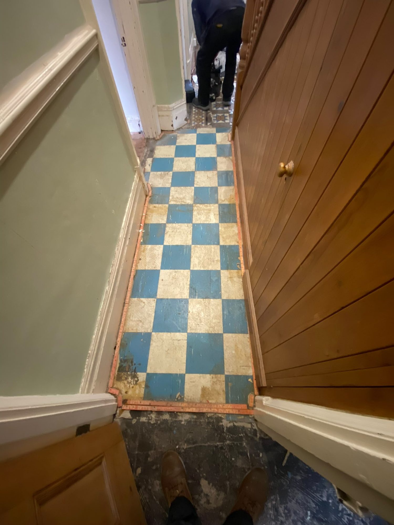Before hallway asbestos floor tile removal in North Wales