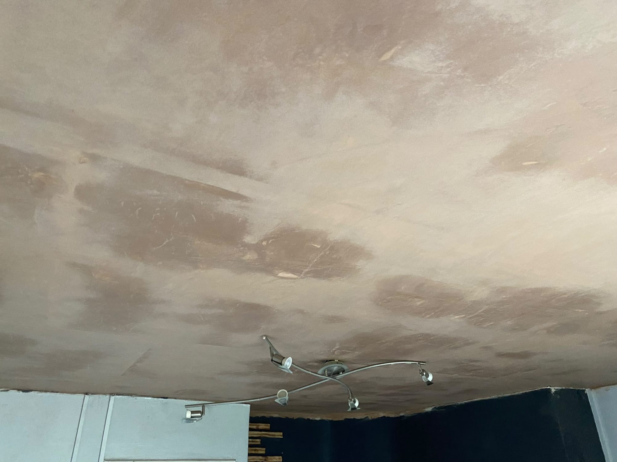 Freshly re-skimmed plaster ceiling in an Anglesey home