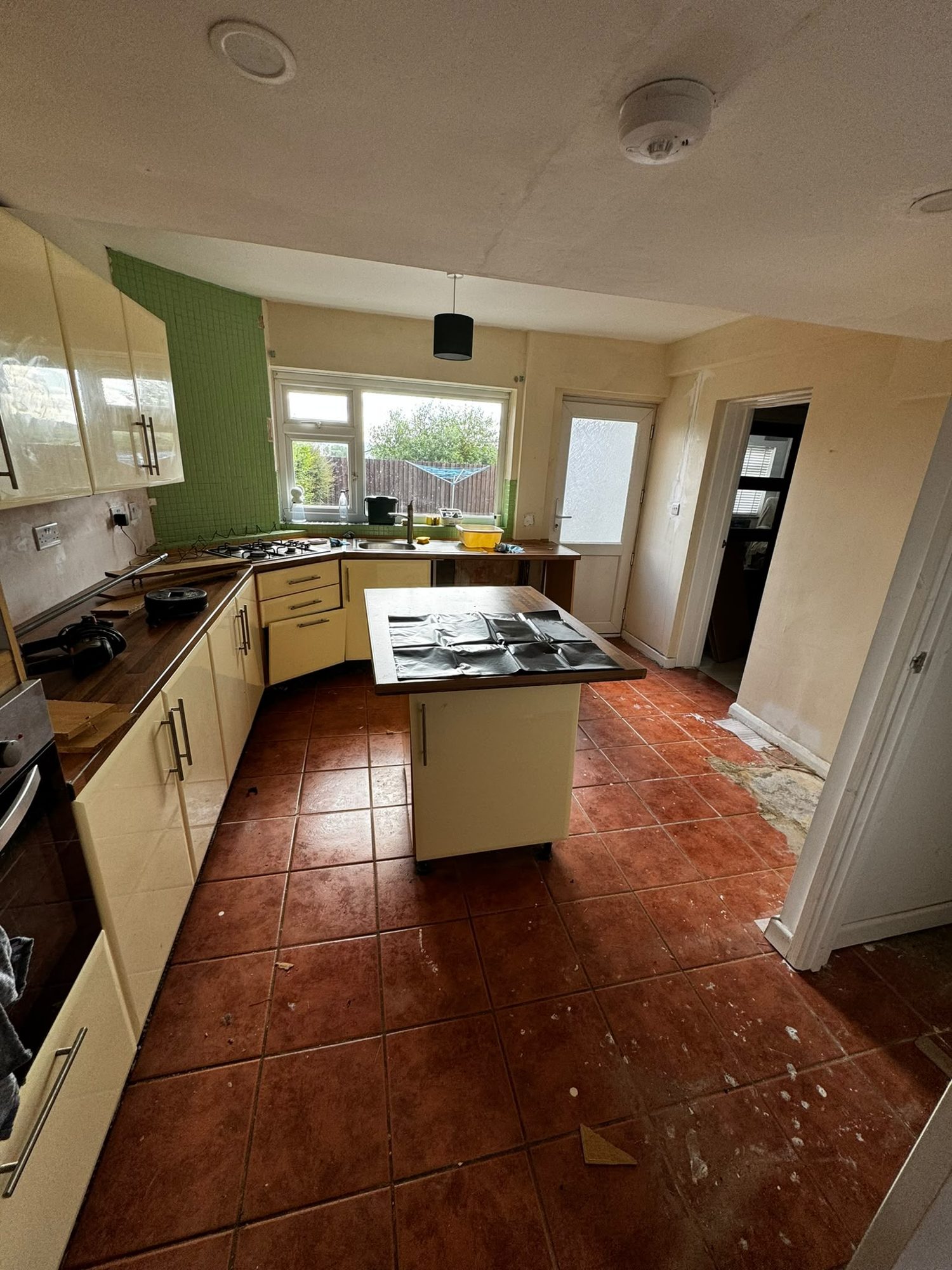 Before kitchen asbestos floor tile removal in Anglesey
