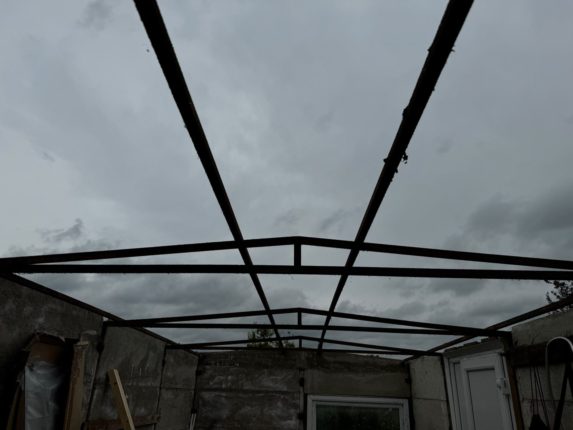 Steel garage frame left after roof demolition in North Wales