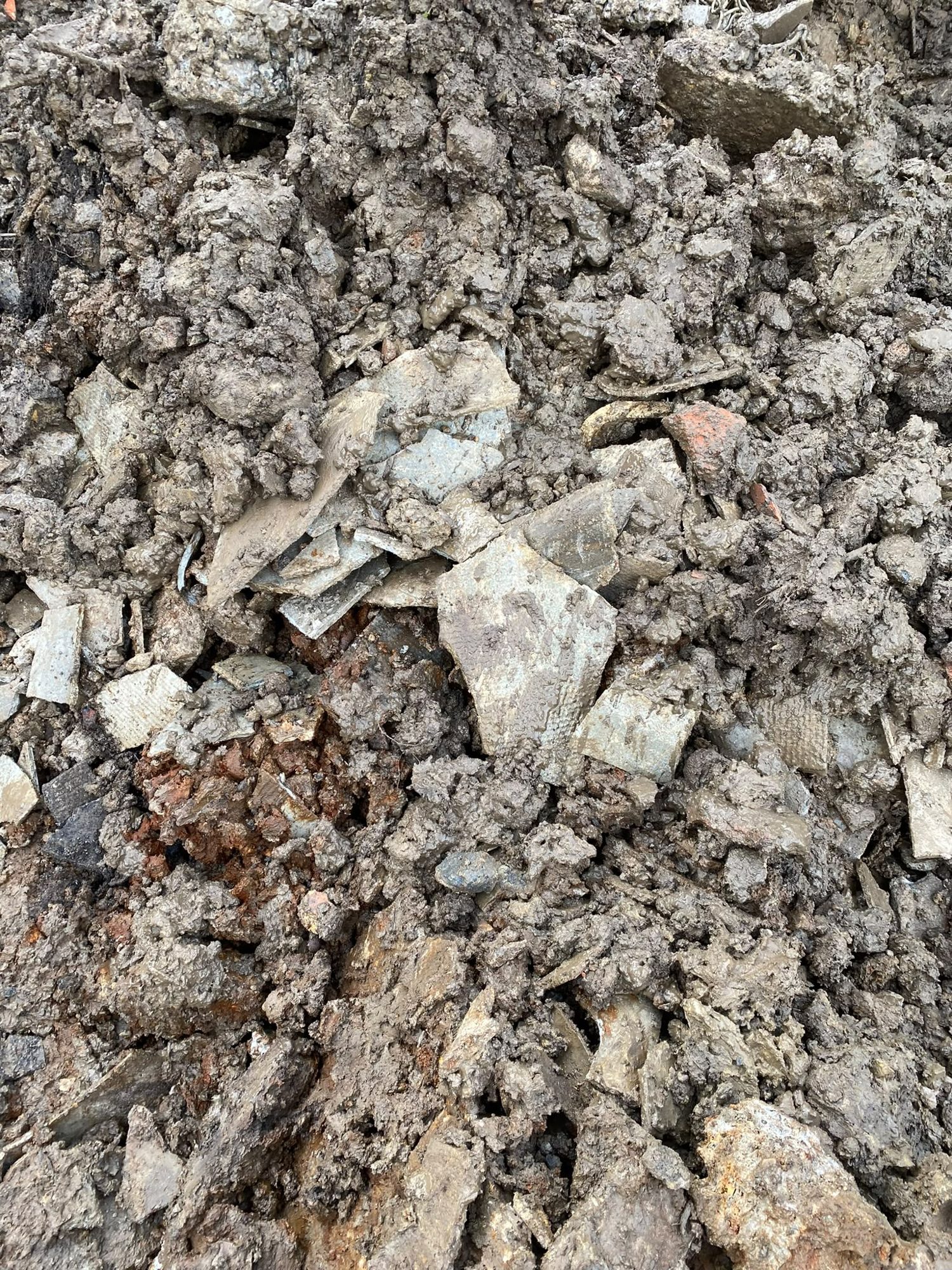 Soil and rubble with broken fragments sampled for asbestos testing in Anglesey