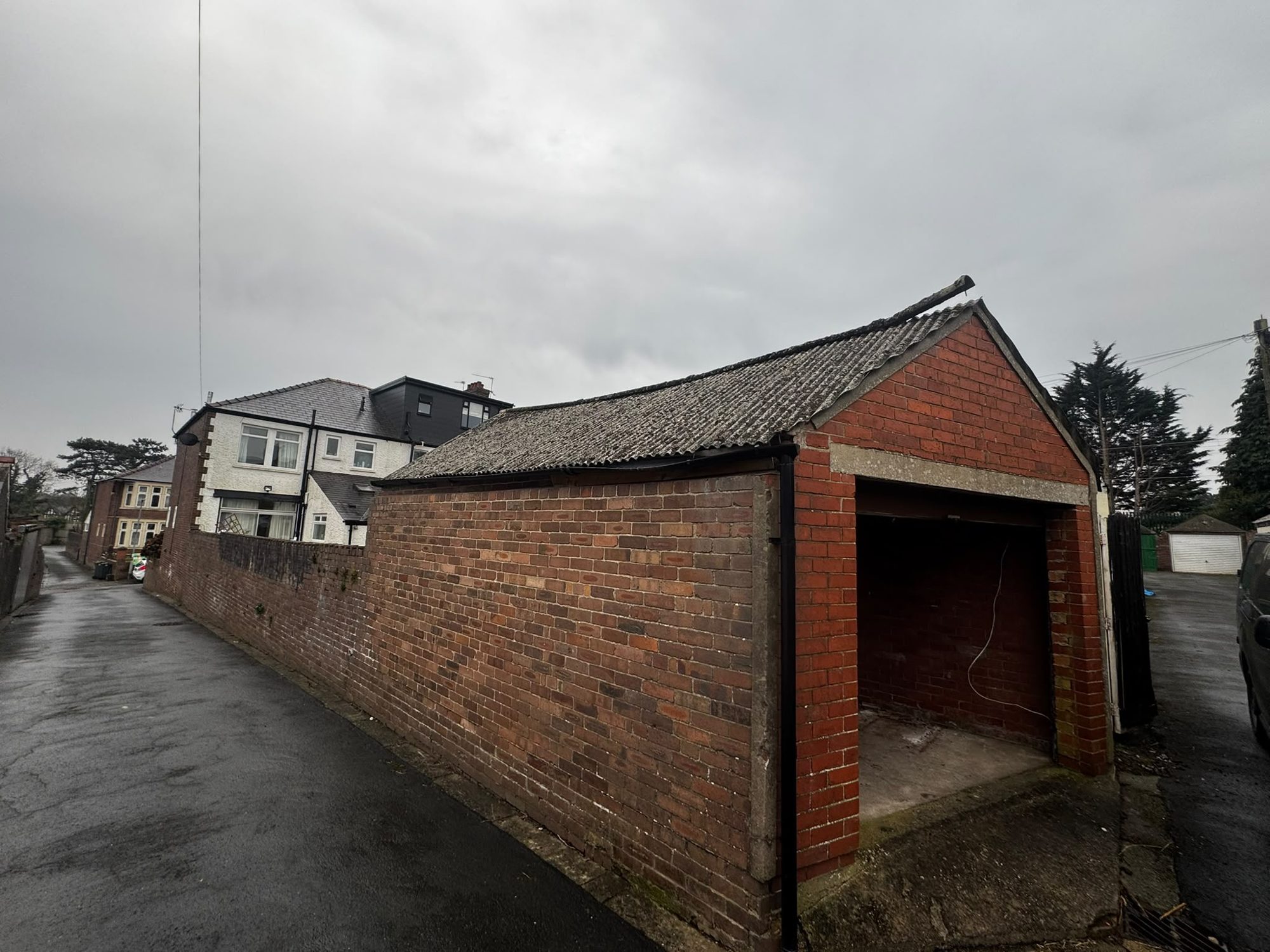 Before brick garage asbestos roof sheet removal in Anglesey