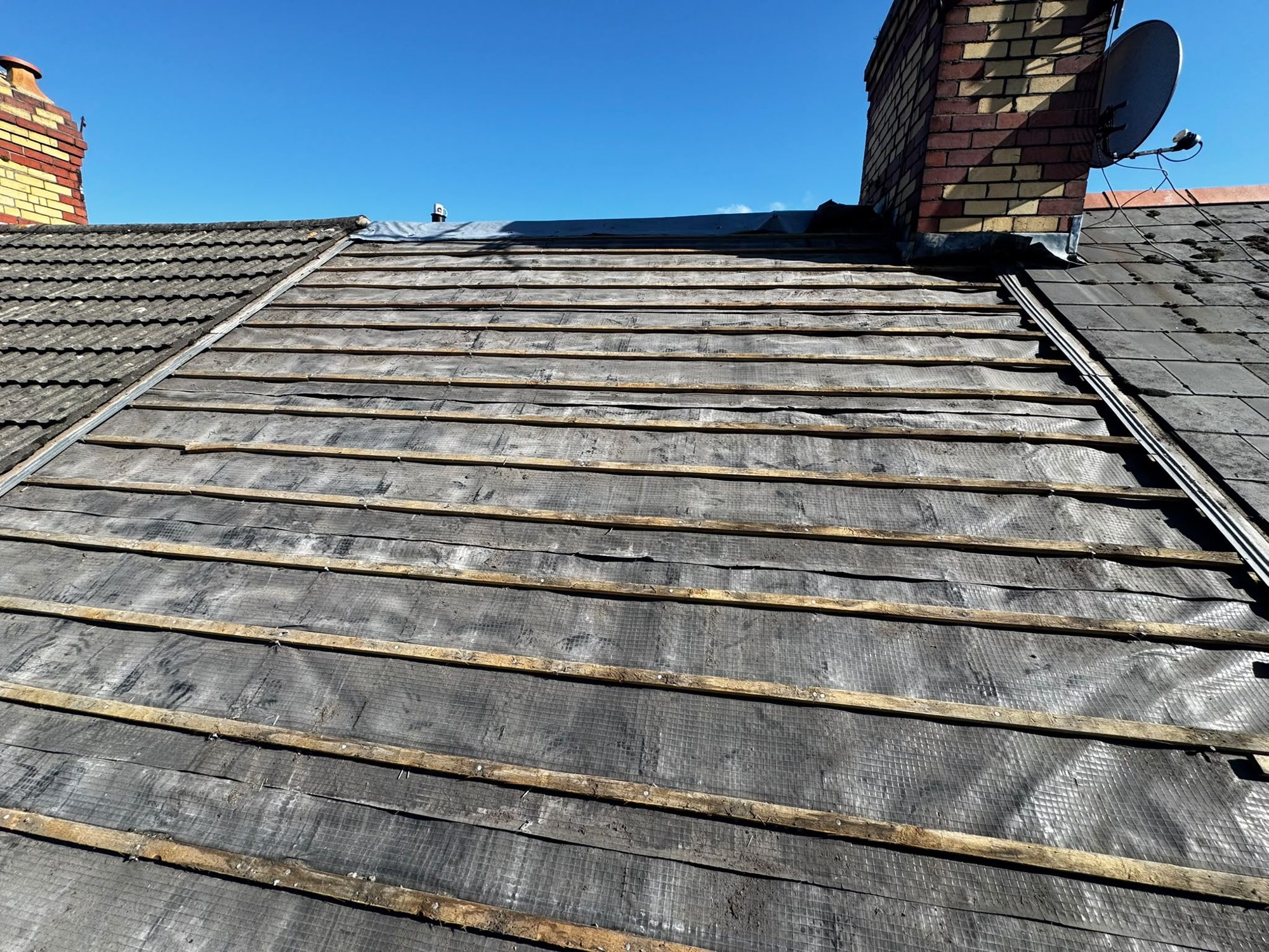 Pitched roof stripped to felt and battens for re-roofing in Anglesey