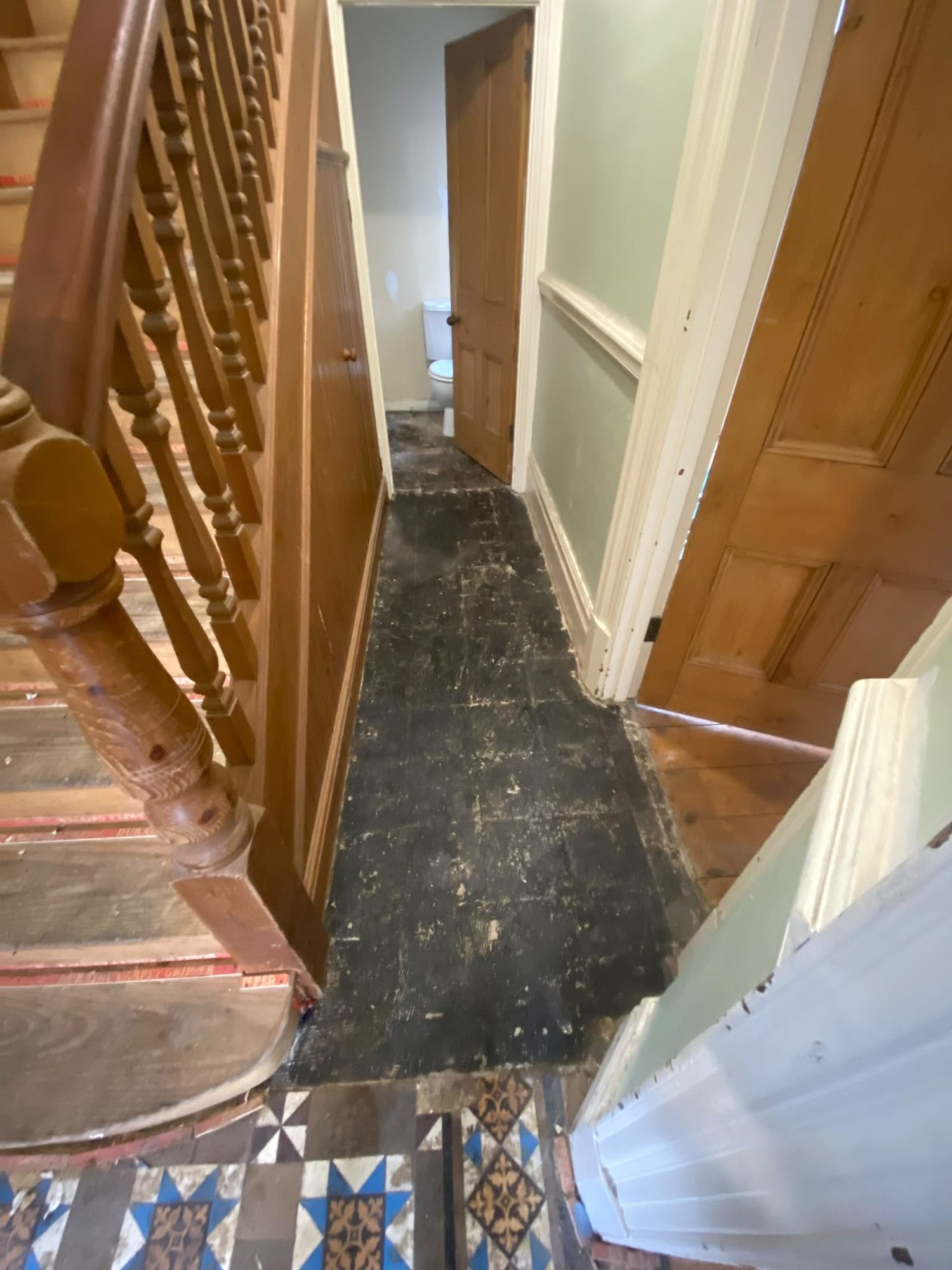 Hallway floor after asbestos tile removal in North Wales