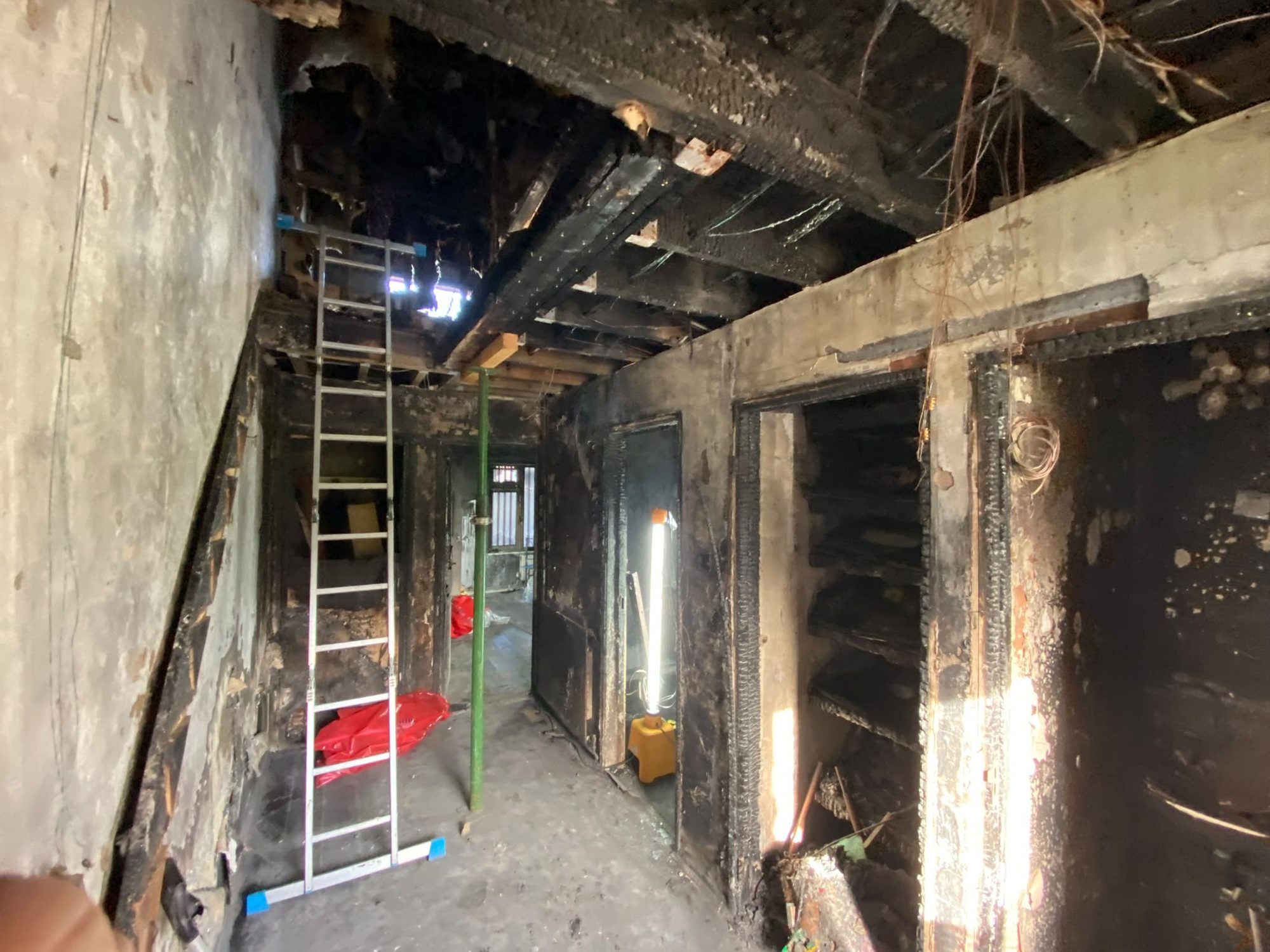 Fire-damaged hallway and ceiling during remediation in Anglesey